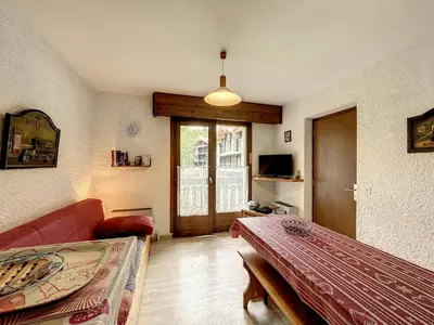 a living room with a couch and a table at Appartement cosy au pied des pistes à Combloux avec balcon et casier à skis - FR-1-560-61 in Combloux