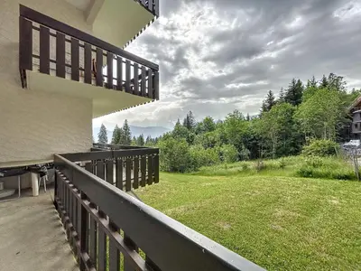a balcony of a house with a view of a yard at Appartement cosy au pied des pistes à Combloux avec balcon et casier à skis - FR-1-560-61 in Combloux