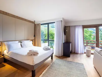 a hotel room with two beds and a tray of food at Novotel Megève Mont-Blanc in Megève