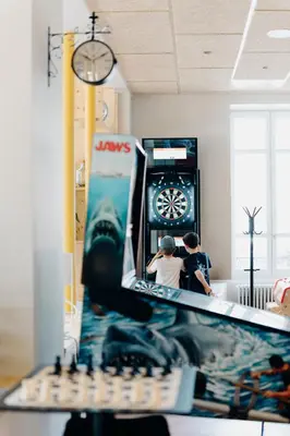 two boys are playing a video game in a store at PlanB - Living Saint-Gervais - 250m des Remontées Mécaniques in Saint-Gervais-les-Bains