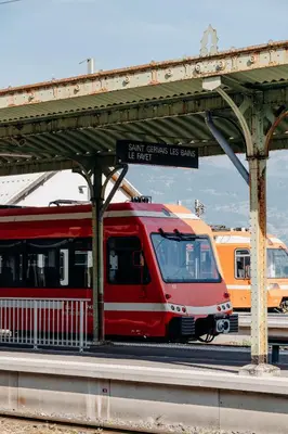 a red train is parked at a train station at PlanB - Living Saint-Gervais - 250m des Remontées Mécaniques in Saint-Gervais-les-Bains