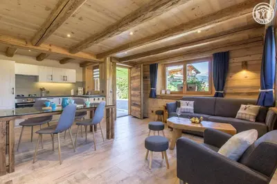 a living room with a couch and a table at Le Granit in Combloux