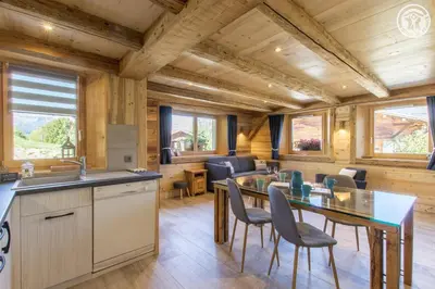 a kitchen and dining room with a table and chairs at Le Granit in Combloux