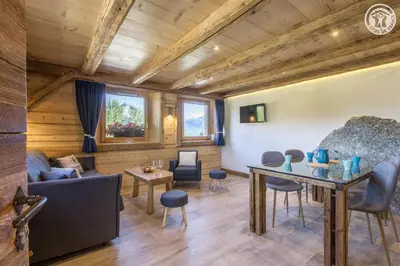a living room with a couch and a table at Le Granit in Combloux