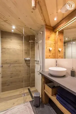 a bathroom with a sink and a glass shower at Le Granit in Combloux