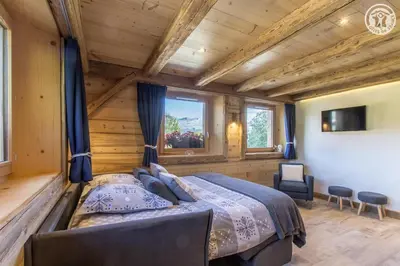 a bedroom with a bed in a log cabin at Le Granit in Combloux
