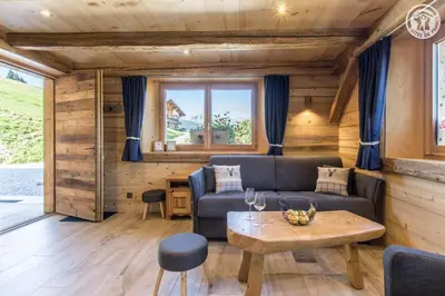 a living room with a couch and a table at Le Granit in Combloux