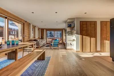 a kitchen and living room with a table and chairs at Residence Le Green in Chamonix-Mont-Blanc