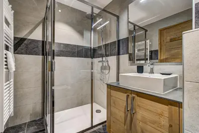 a bathroom with a sink and a shower at Residence Le Green in Chamonix-Mont-Blanc