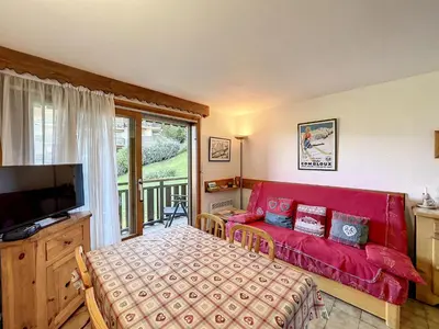 a living room with a red couch and a television at Studio cabine proche centre Combloux, 4 pers, balcon, parking - FR-1-560-53 in Combloux
