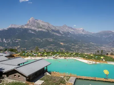 a large swimming pool with a mountain in the background at Studio cabine proche centre Combloux, 4 pers, balcon, parking - FR-1-560-53 in Combloux