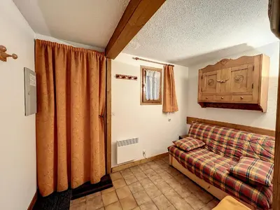 a bedroom with a bed and a curtain and a window at Studio cabine proche centre Combloux, 4 pers, balcon, parking - FR-1-560-53 in Combloux
