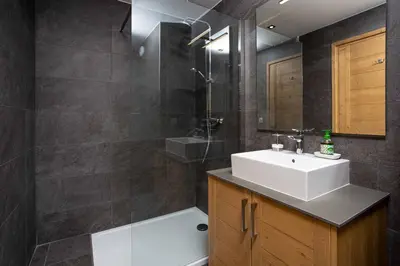 a bathroom with a sink and a shower at Coin des Drus Apartment - Chamonix All Year in Chamonix-Mont-Blanc