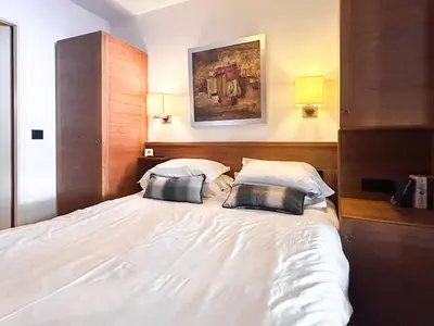 a bedroom with a white bed with two pillows at 2 Bed Ski in and Ski out Luxury Apt in 5 star Residence in Flaine