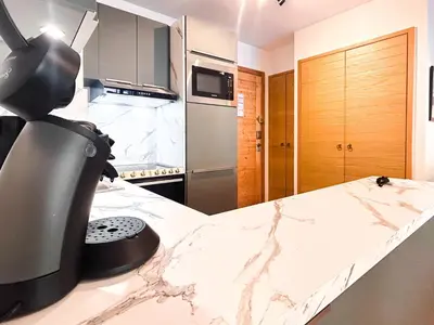 a kitchen with a appliance on top of a counter at 2 Bed Ski in and Ski out Luxury Apt in 5 star Residence in Flaine