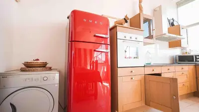 a kitchen with two wooden stools at a counter at Gite74, GLMB à 3 min de l'ascenseur des Thermes in Saint-Gervais-les-Bains