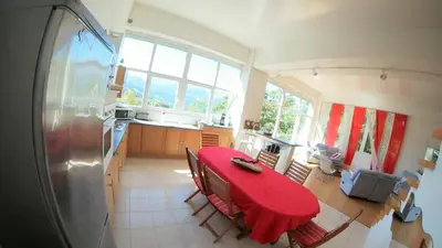 a red refrigerator in a kitchen with a washing machine at Gite74, GLMB à 3 min de l'ascenseur des Thermes in Saint-Gervais-les-Bains