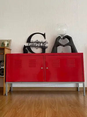 a red cabinet with a lamp on top of it at Gite74, GLMB à 3 min de l'ascenseur des Thermes in Saint-Gervais-les-Bains
