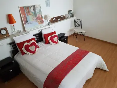 a bedroom with a bed with red and white pillows at Gite74, GLMB à 3 min de l'ascenseur des Thermes in Saint-Gervais-les-Bains