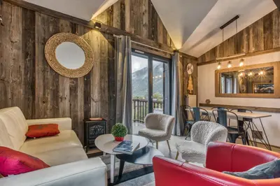 a living room with wooden walls and chairs and a table at Alta Rocca in Chamonix-Mont-Blanc