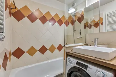 a bathroom with a sink and a washing machine at Alta Rocca in Chamonix-Mont-Blanc