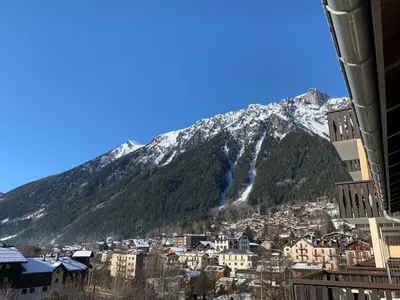 a city with a snow covered mountain in the background at Alta Rocca in Chamonix-Mont-Blanc