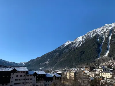 a city with snow covered mountains in the background at Alta Rocca in Chamonix-Mont-Blanc