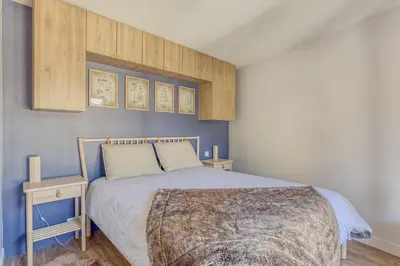 a bedroom with a large bed and two tables at Rare ! Appartement rénové dans le centre piéton de Megève in Megève