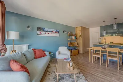 a living room with a couch and a table at Rare ! Appartement rénové dans le centre piéton de Megève in Megève