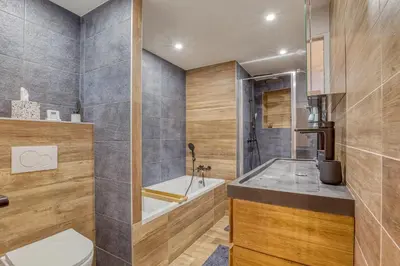 a bathroom with a tub and a toilet and a sink at Rare ! Appartement rénové dans le centre piéton de Megève in Megève
