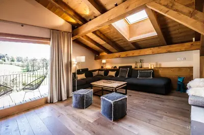 a living room with a couch and a table at Ski in ski out Le Moulin charming duplex just 50 m from Princesse gondola Megève in Demi-Quartier