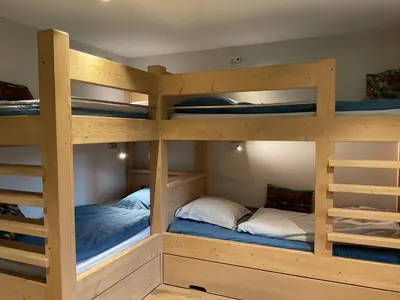 a bunk bed room with three bunk beds at Ski in ski out Le Moulin charming duplex just 50 m from Princesse gondola Megève in Demi-Quartier