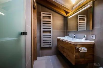 a bathroom with a sink and a mirror at Ski in ski out Le Moulin charming duplex just 50 m from Princesse gondola Megève in Demi-Quartier