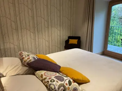 a bedroom with a bed with pillows and a window at Ski in ski out Le Moulin charming duplex just 50 m from Princesse gondola Megève in Demi-Quartier