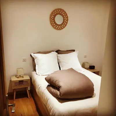 a bed with a brown pillow on top of it at LE 