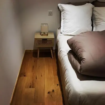 a bedroom with a bed and a night stand with a side table at LE 
