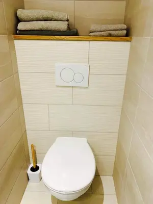 a white toilet in a bathroom with towels at LE 