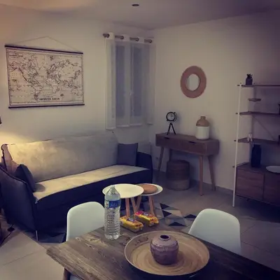 a living room with a couch and a table at LE 