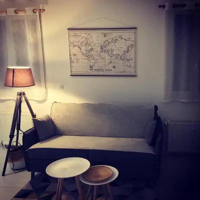 a living room with a couch and two tables at LE 