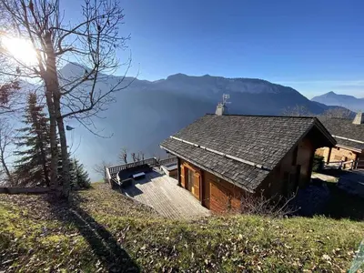 a house on a hill with a view of a mountain at Chalet 3 chambres 8 pers avec cheminée et parking à 1000m des pistes - FR-1-572-49 in Les Carroz d'Araches