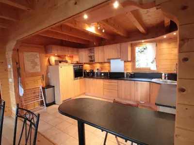 a large kitchen with a table in a cabin at Chalet 3 chambres 8 pers avec cheminée et parking à 1000m des pistes - FR-1-572-49 in Les Carroz d'Araches