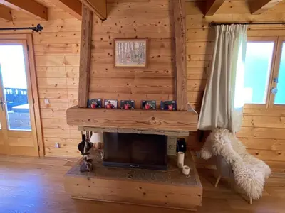 a living room with a fireplace in a log cabin at Chalet 3 chambres 8 pers avec cheminée et parking à 1000m des pistes - FR-1-572-49 in Les Carroz d'Araches