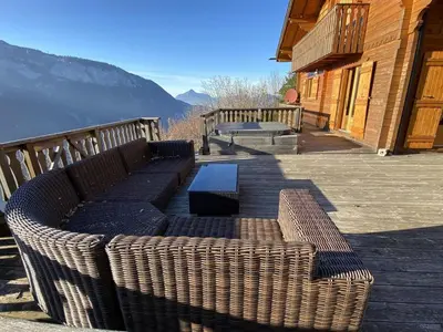 two benches on a deck with a view of the mountains at Chalet 3 chambres 8 pers avec cheminée et parking à 1000m des pistes - FR-1-572-49 in Les Carroz d'Araches