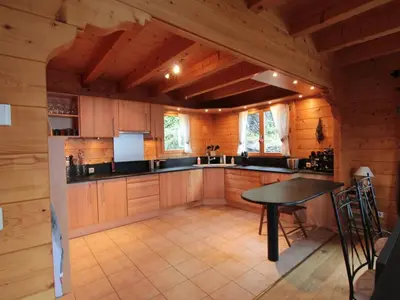 a large kitchen with a table in a cabin at Chalet 3 chambres 8 pers avec cheminée et parking à 1000m des pistes - FR-1-572-49 in Les Carroz d'Araches