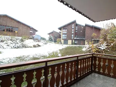 a balcony with snow on the ground and buildings at Appartement 3 chambres, 2 sdb, parking, proche pistes, équipements de standing - FR-1-572-46 in Les Carroz d'Araches