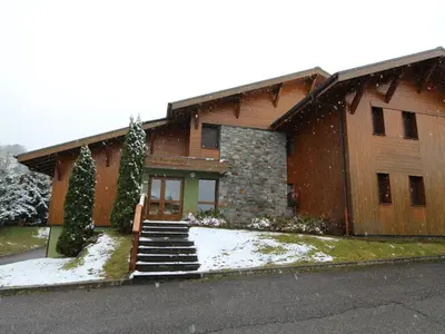 a house with snow on the front of it at Appartement 3 chambres, 2 sdb, parking, proche pistes, équipements de standing - FR-1-572-46 in Les Carroz d'Araches