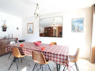 a dining room table with a checkered table cloth at Appartement 3 chambres, 2 sdb, parking, proche pistes, équipements de standing - FR-1-572-46 in Les Carroz d'Araches