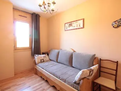 a living room with a couch and a window at Appartement 3 chambres, 2 sdb, parking, proche pistes, équipements de standing - FR-1-572-46 in Les Carroz d'Araches