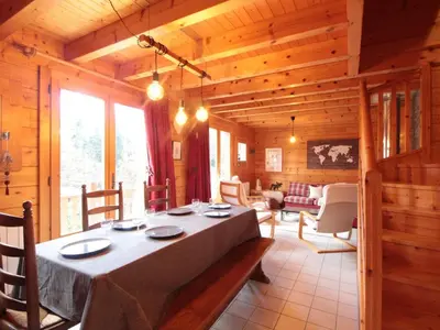 a dining room with a table in a cabin at Chalet équipé avec poêle et garage, proche centre et remontées mécaniques - FR-1-572-107 in Les Carroz d'Araches