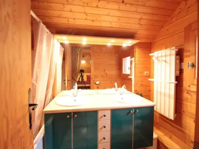 a bathroom with two sinks in a wooden room at Chalet équipé avec poêle et garage, proche centre et remontées mécaniques - FR-1-572-107 in Les Carroz d'Araches